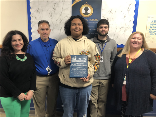 Jesus Vizcarrondo Jr., Wilson's November Stairclimber, poses with his plaque and school staff.